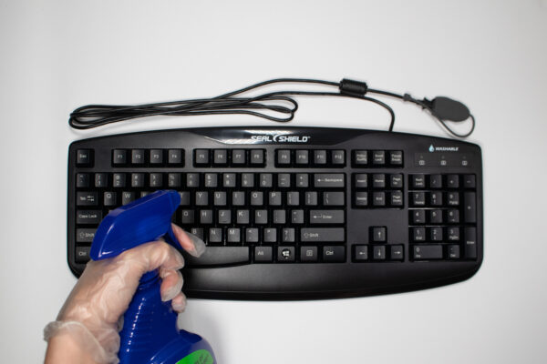 STK503 washable keyboard being cleaned by a spray