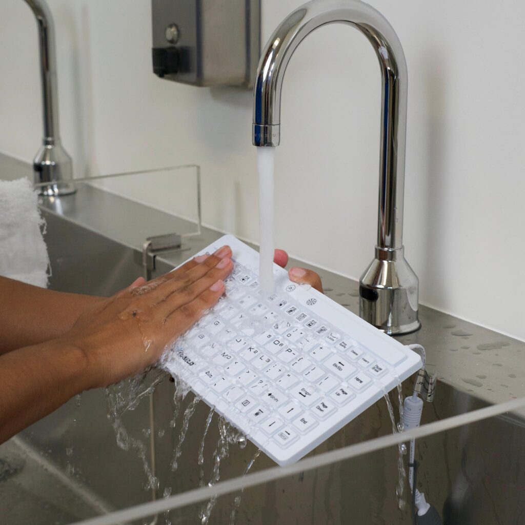 Seal Shield's 89 series quiet keyboard being washed in a sink